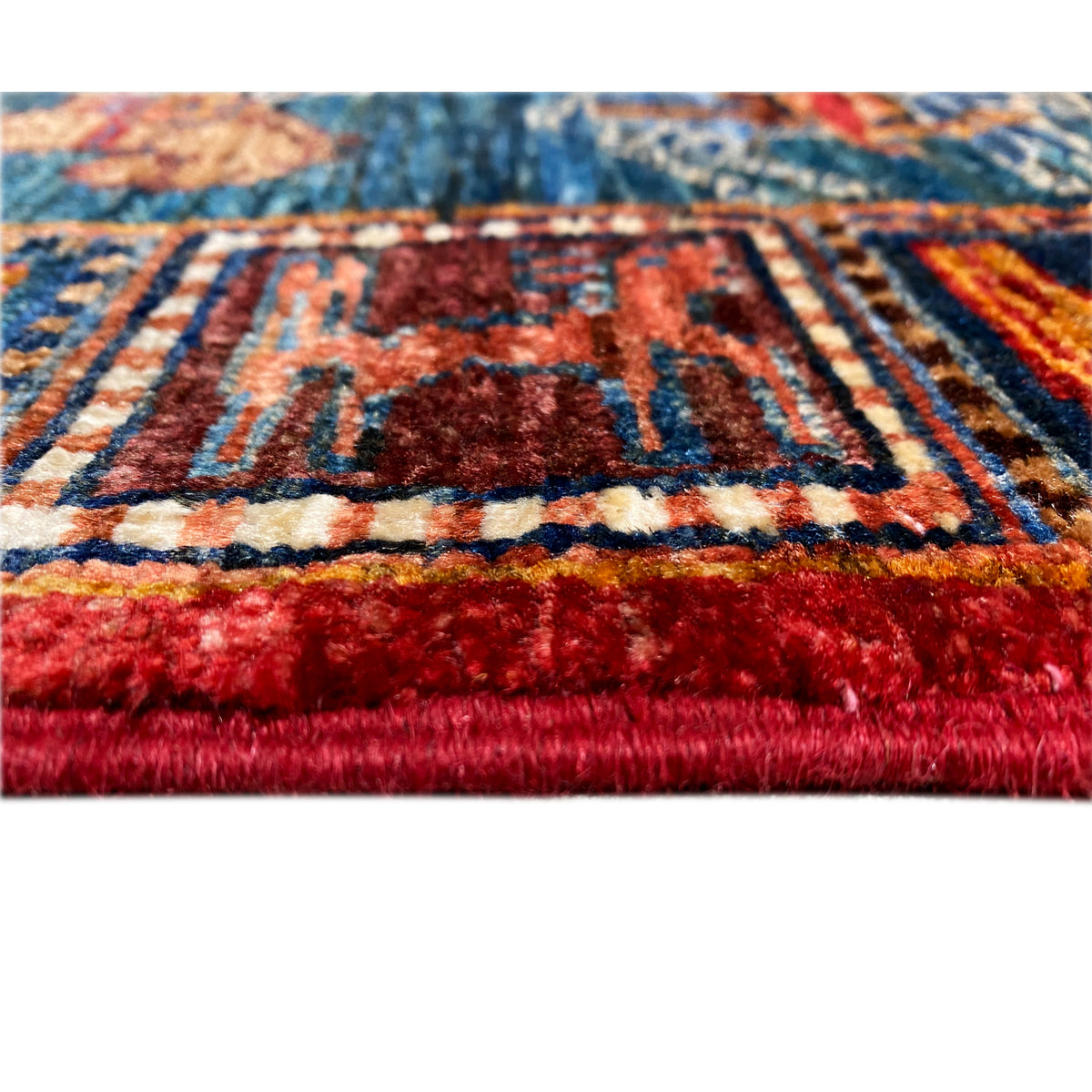Close-up: selvedge with tassels and red pile along the edge of the Khorjin runner.