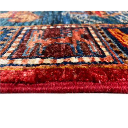 Close-up: selvedge with tassels and red pile along the edge of the Khorjin runner.
