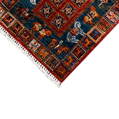 Edge detail with tassels on the hand-knotted Khorjin runner, blue field with animal motifs.