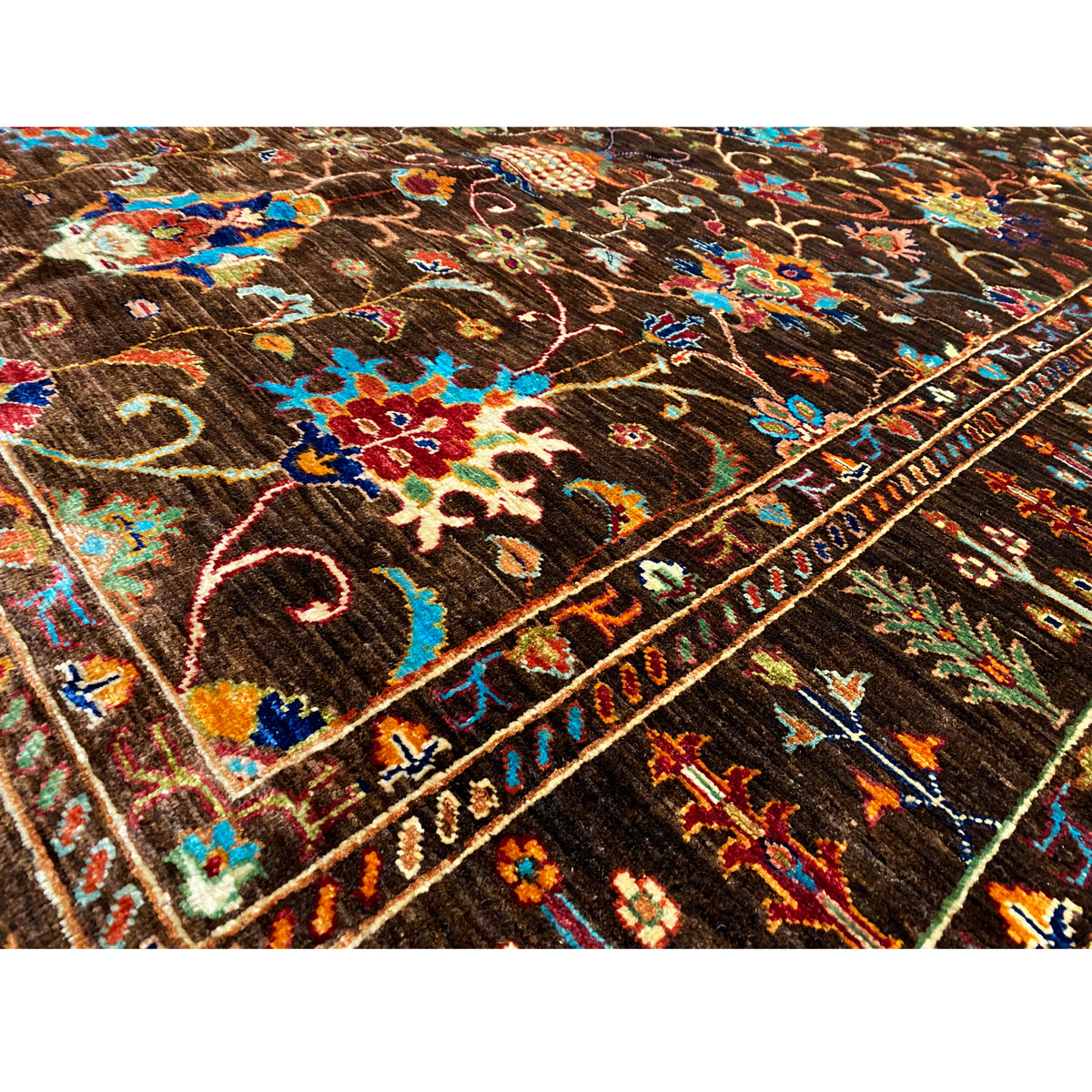 Detailed view: Hand-knotted Khorjin rug with colorful floral and vine ornaments