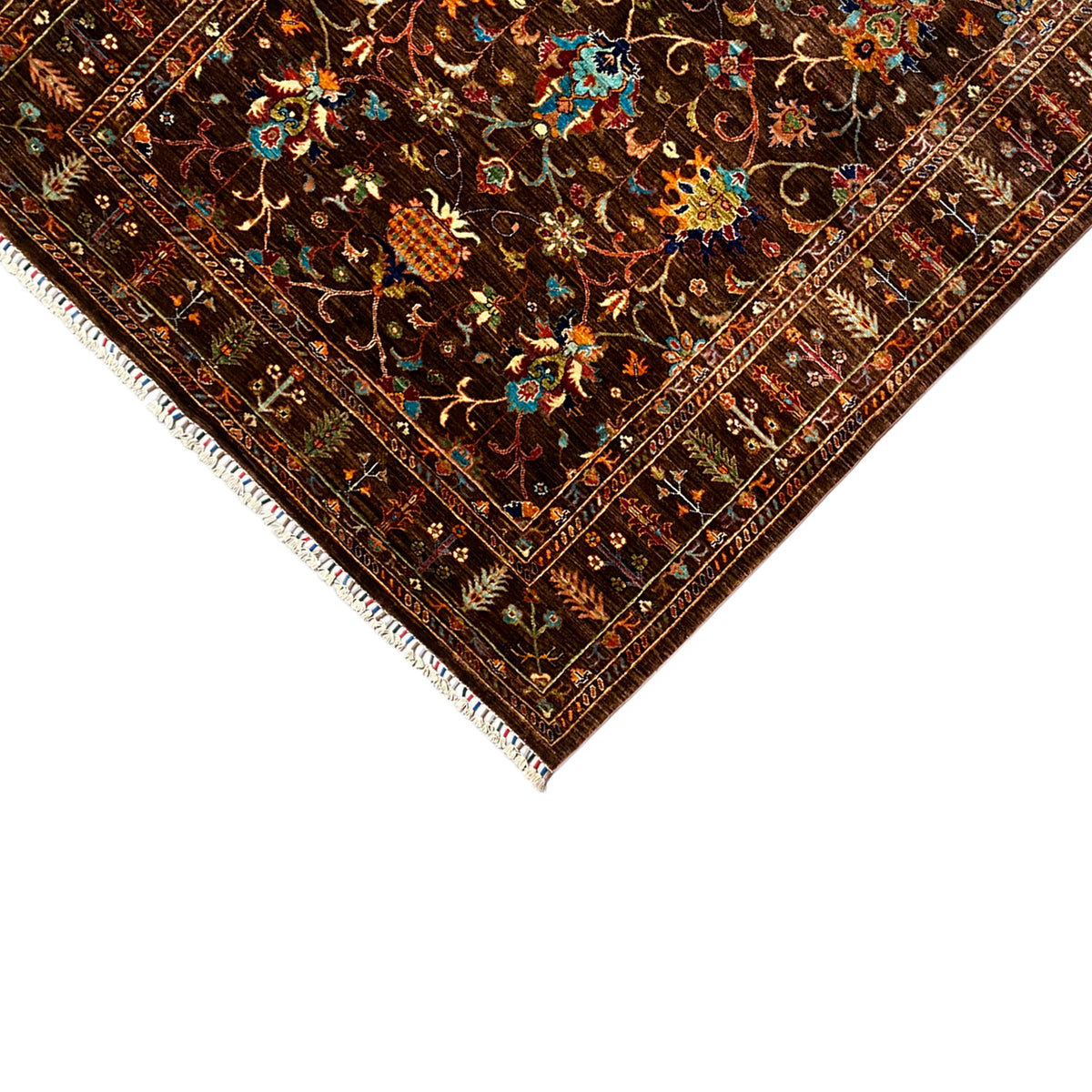 Corner and edge view of the hand-knotted Khorjin rug with fringed trim