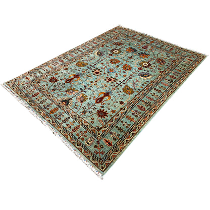 Corner view of a Khorjin rug: turquoise background, decorative border, and floral pattern
