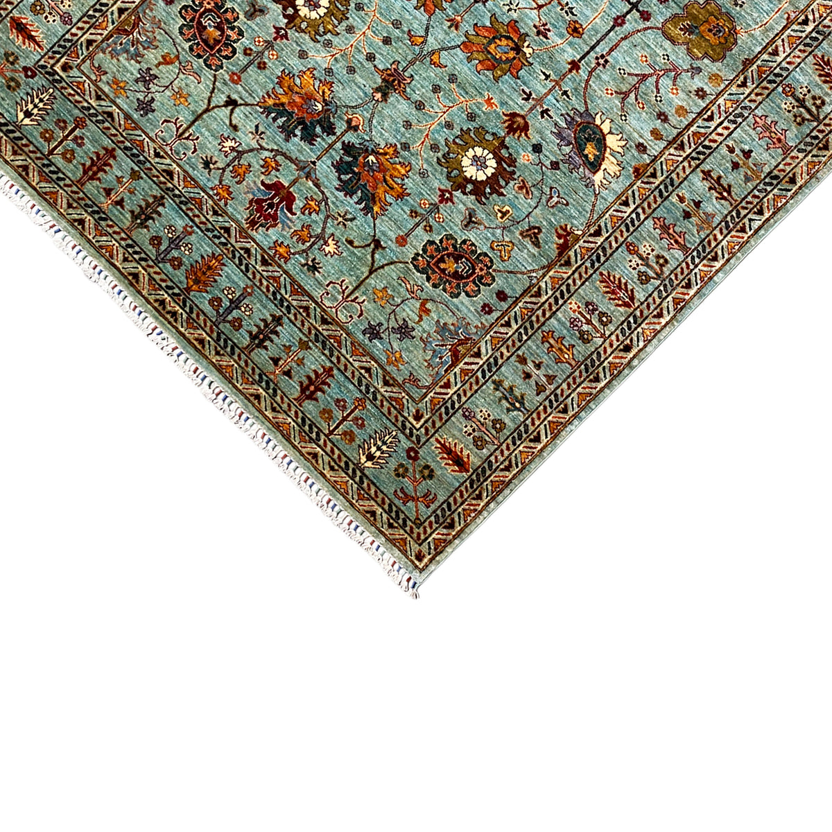 Edge and fringe of the Khorjin carpet: turquoise, multicolored ornaments and diamond patterns