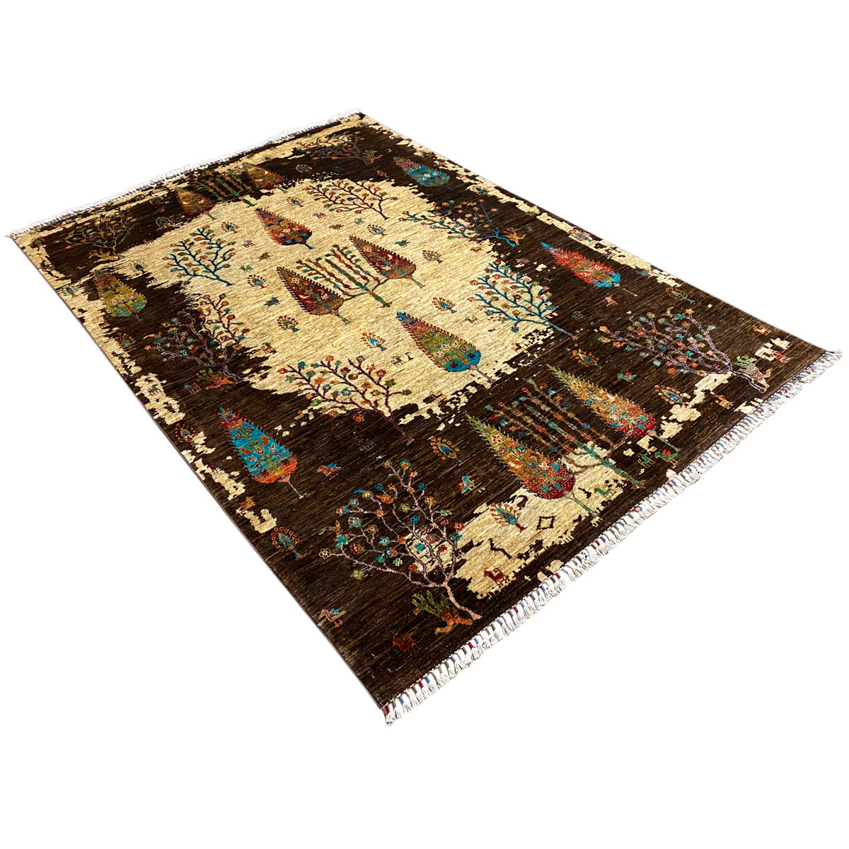 Hand-knotted Khorjin rug shown at an angle, brown with a beige field and tree-and-bird motifs