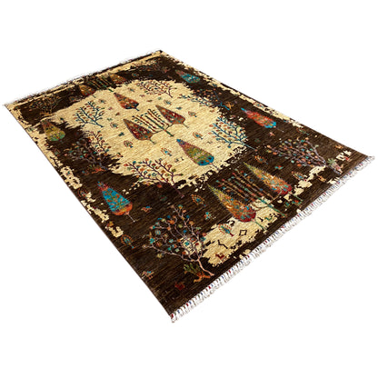 Hand-knotted Khorjin rug shown at an angle, brown with a beige field and tree-and-bird motifs