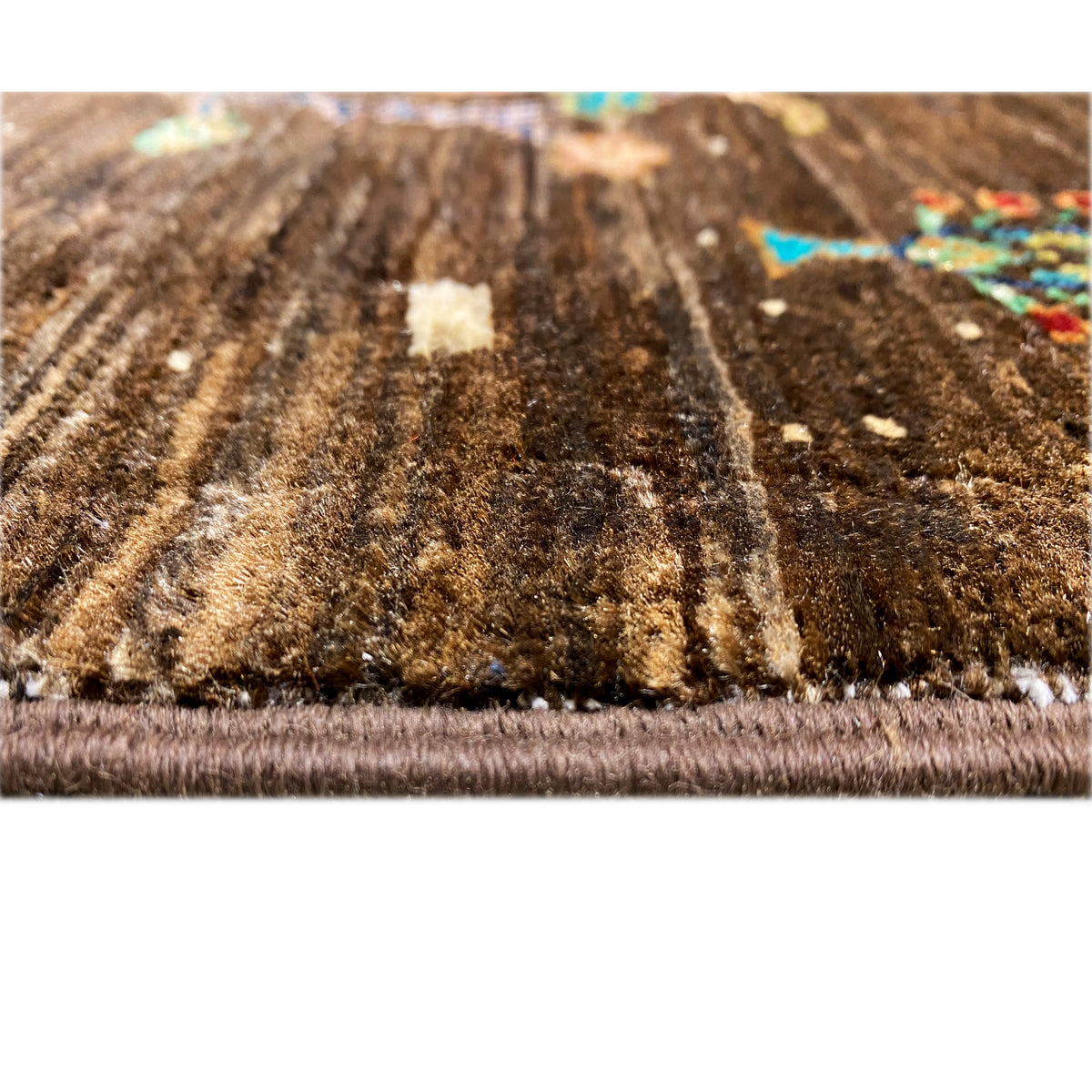 Hand-knotted Khorjin rug close-up of the pile surface and edge fringes, brown