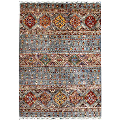 Rug with a geometric tribal design in gray, red, blue, yellow, and white fringe