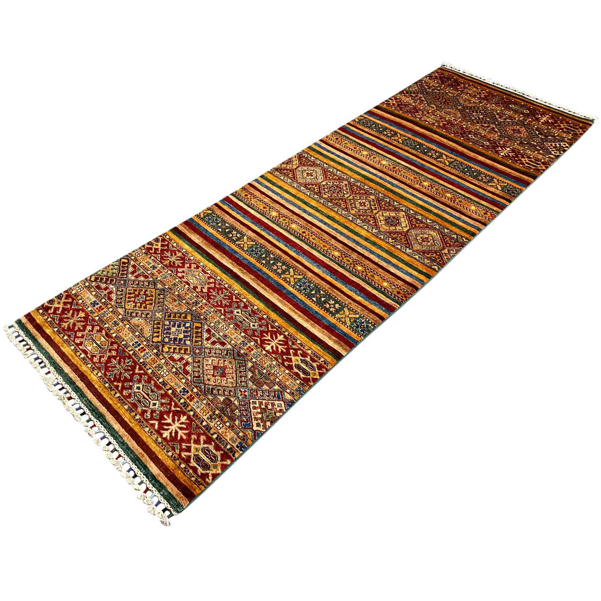 Runner rug with a striped border, geometric patterns, and tassels along the edge