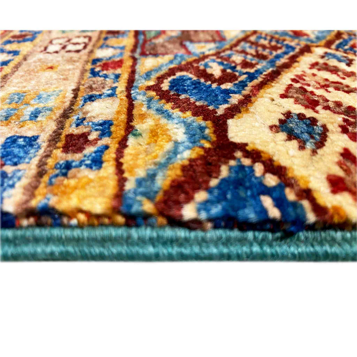 Detail of the runner rug: woven patterns in blue, red, and yellow