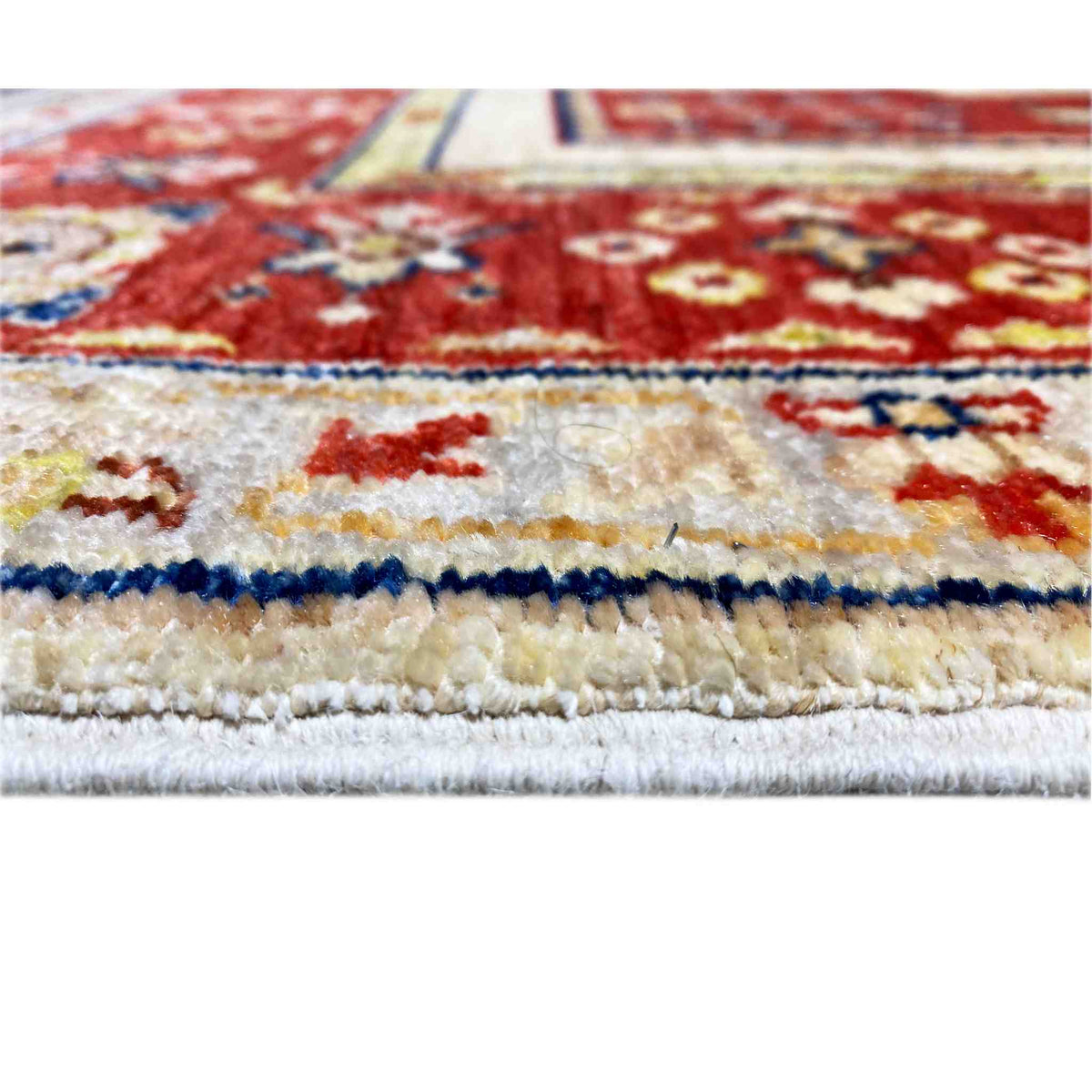 Khorjin rug close-up: multicolored patterns and visible pile edge at the border