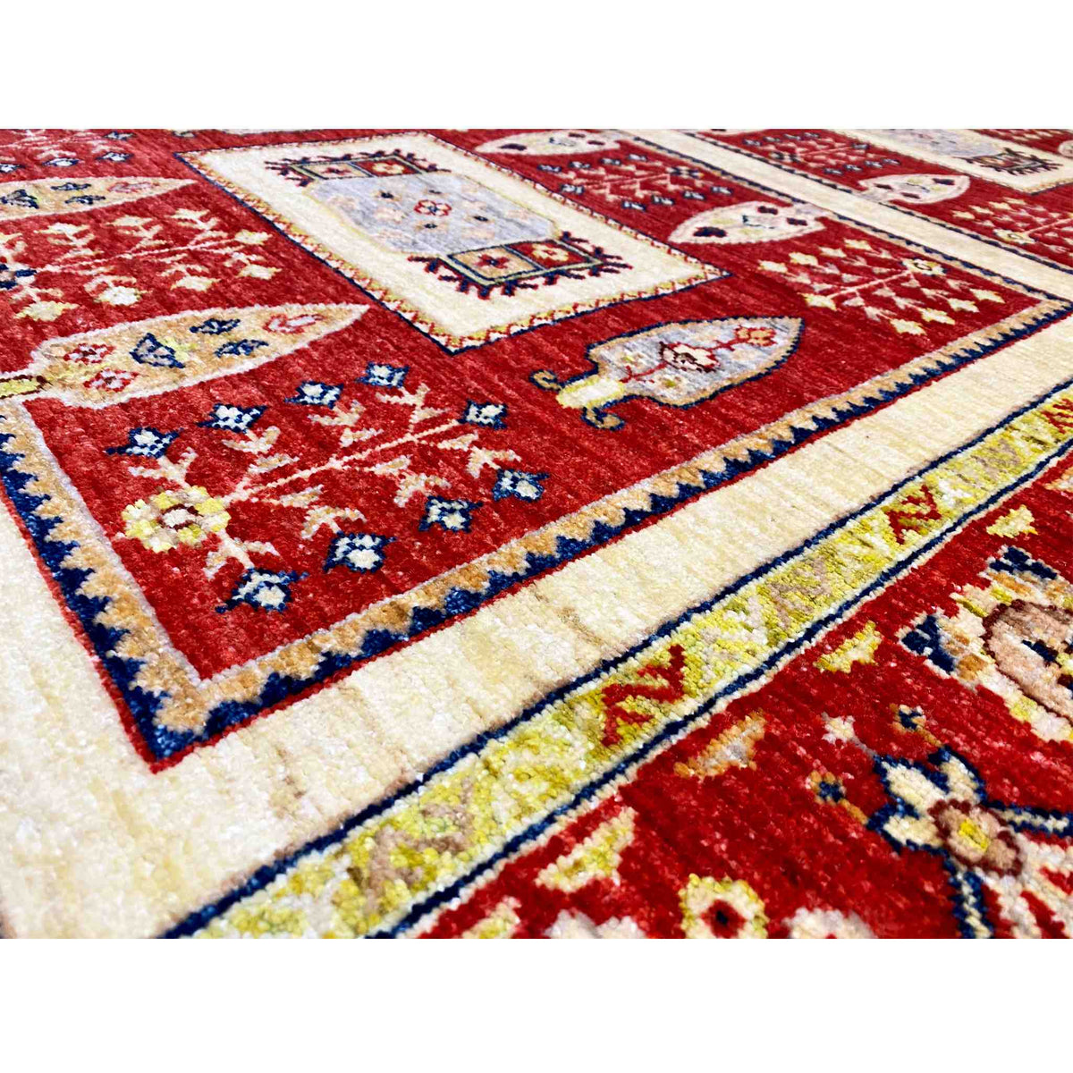 Khorjin rug detail view: red field with colorful ornaments and a cream-colored border