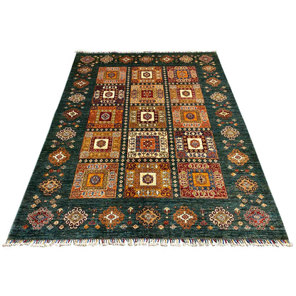 Rug with a blue-green background, square ornamental panels, and fringes all around