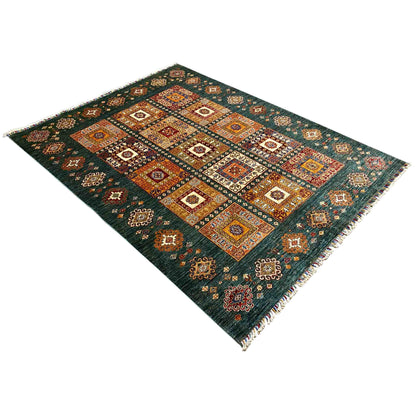 Teal rug with geometric diamond and tile patterns, corners with fringes