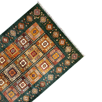 Rug from the corner: blue-green, symmetrical tiles with ornaments, fringes all around