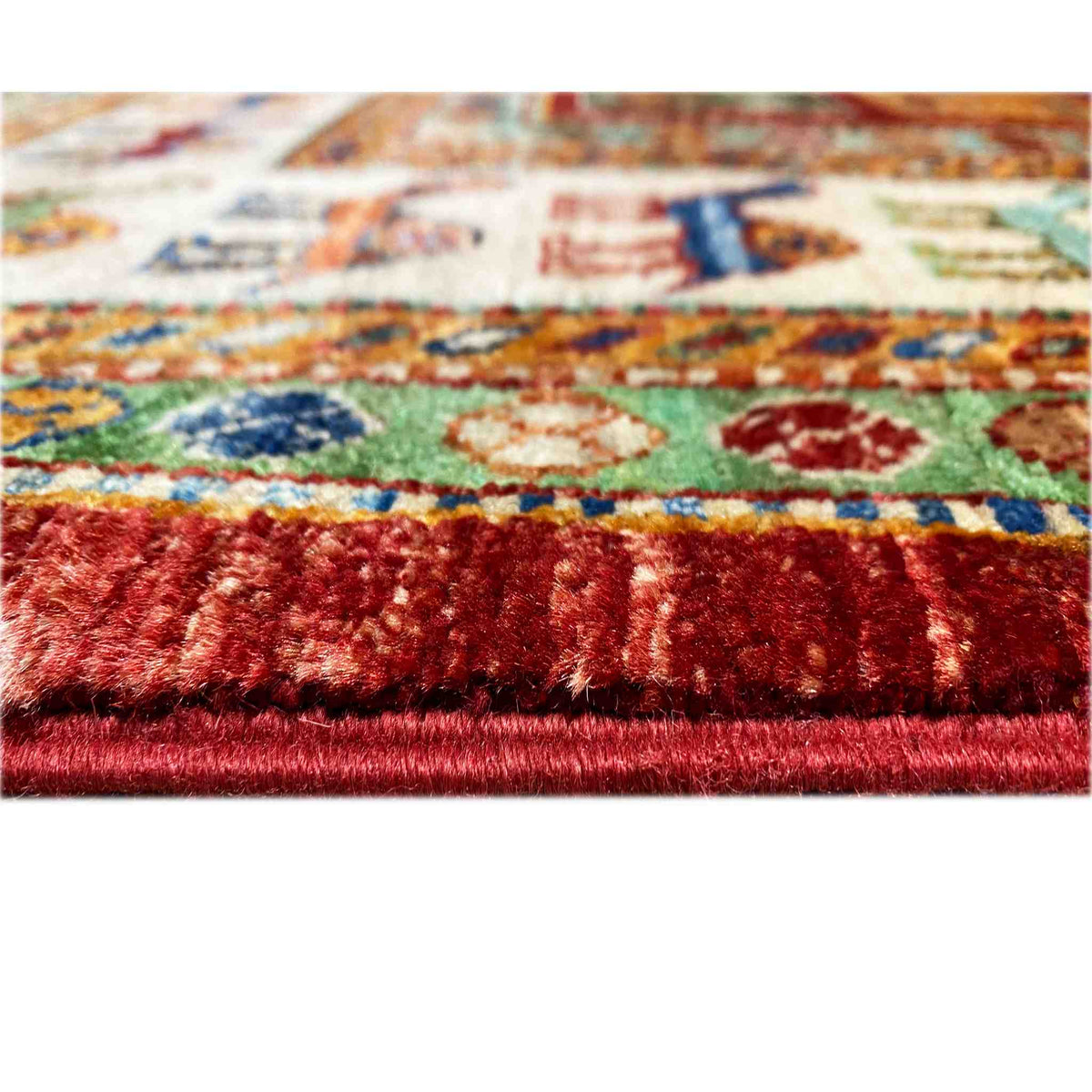 Close-up: carpet with a dense pile and multicolored pattern, red edge