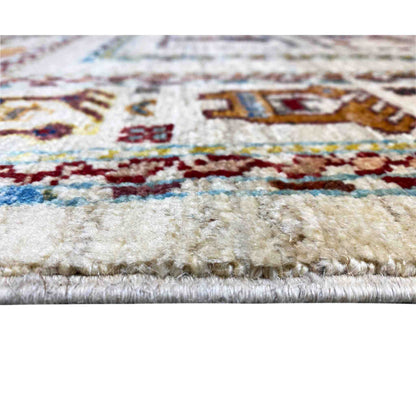 Carpet detail: pile with colorful embroidered patterns and a multicolored border
