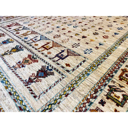 Close-up of a rug with a light background, framed motifs, and decorative bands