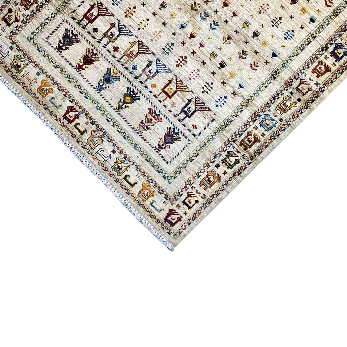 Carpet detail at the corner: light-colored area, colorful ornaments, and bordered edge