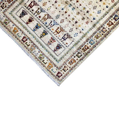 Carpet detail at the corner: light-colored area, colorful ornaments, and bordered edge