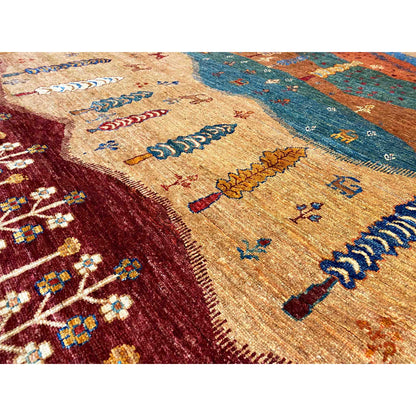 Detailed view of the carpet pattern with a golden-brown field, blue stripes, and colored embroidered lines.