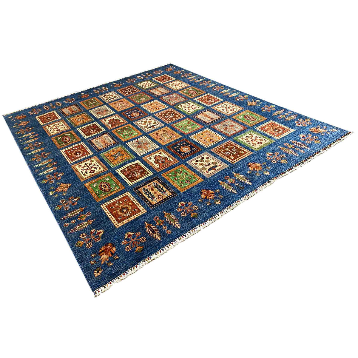 Blue rug with a Khorjin tile pattern, colorful squares, and fringes