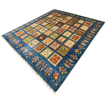 Blue rug with a Khorjin square pattern, colorful panels, and fringes along the edge
