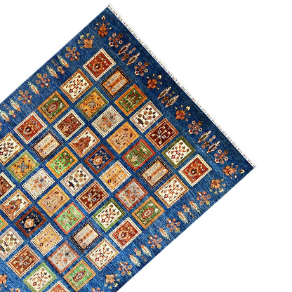 Blue rug with Khorjin panel design, colorful tiles, decorative stitching along the edge