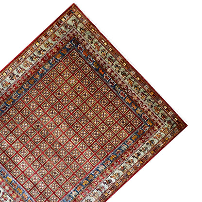 Khorjin rug at an angle: red diamond pattern with a blue border and surrounding bands