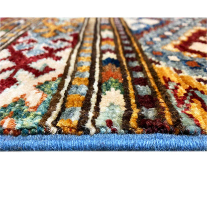 Rug detail with a colorful pattern and thick pile edge, visible fringes along the border