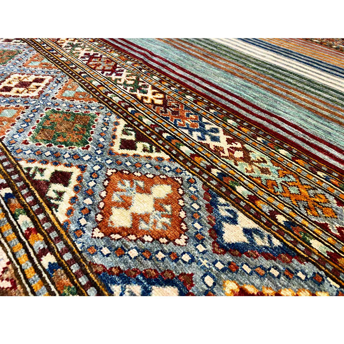 Close-up: geometric ornaments and multicolored stripes in the carpet weave
