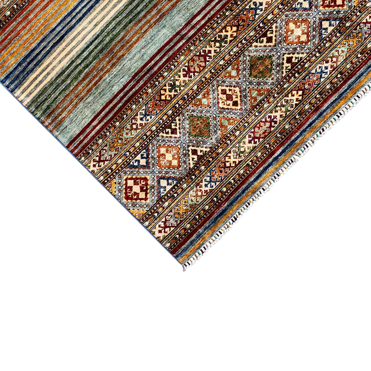 Carpet corner with multicolored stripes, diamond pattern, and fringe along the edge
