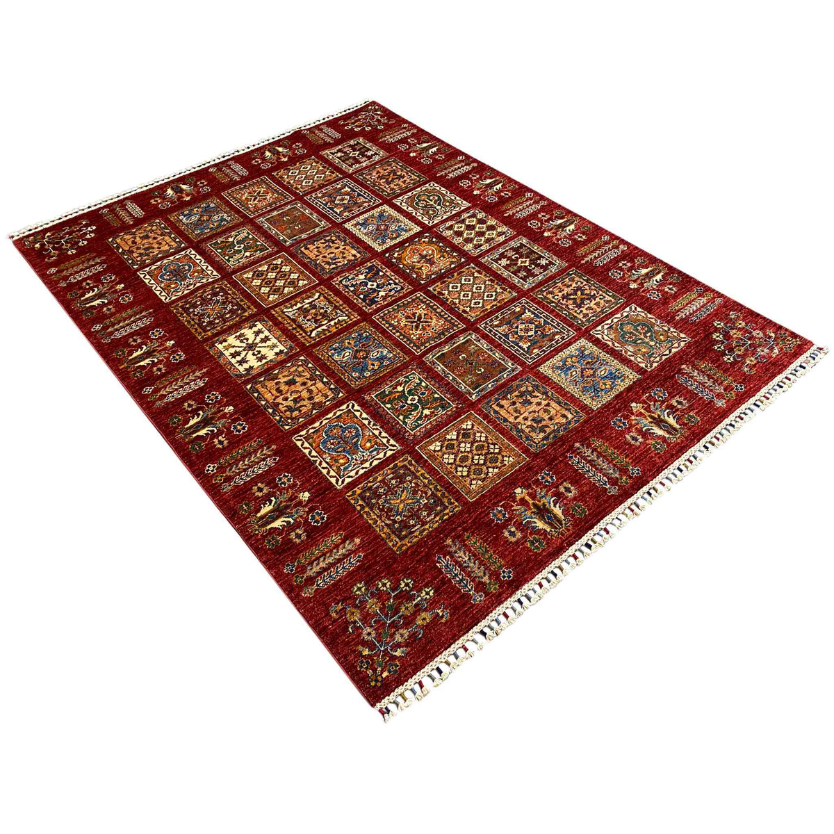 Red carpet with tile-like ornamental panels, diagonal view, fringed edge