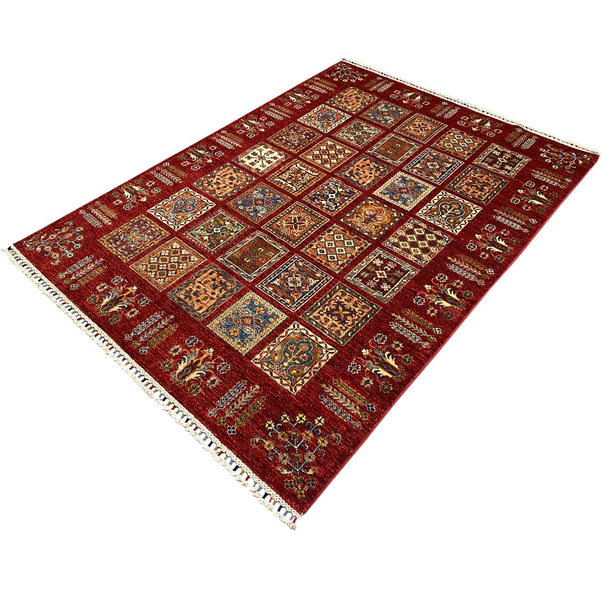 Red carpet with a square patchwork design and fringed border, rotated view