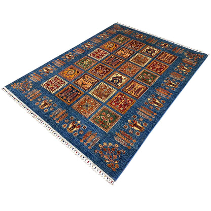 Blue Khorjin rug with a central square grid, colorful motifs, and fringed edges
