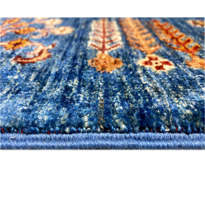 Close-up of a Khorjin rug: blue pile, colorful ornaments, and a visible fringed edge