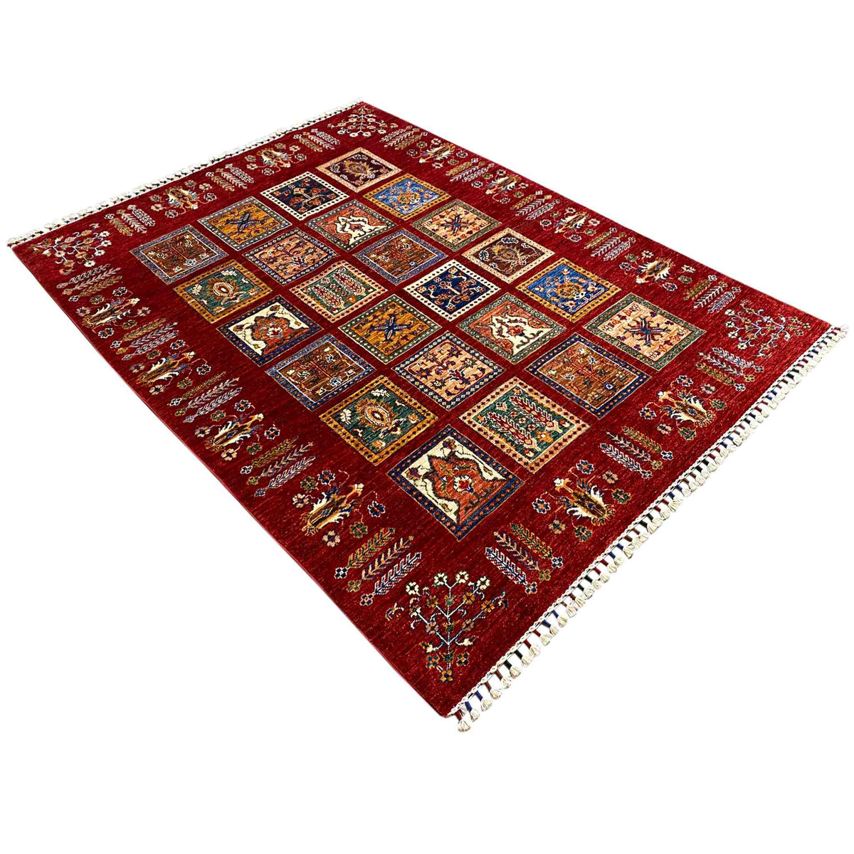 Red Khorjin rug in diagonal view with a rectangular diamond pattern and fringes