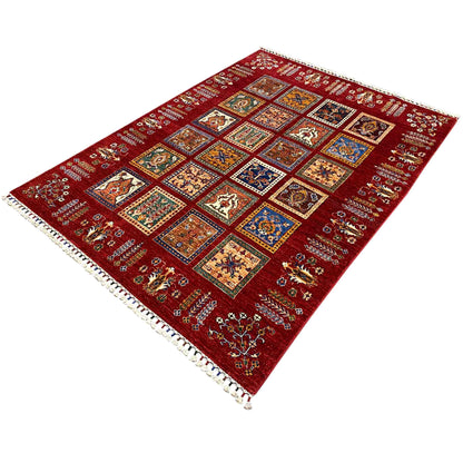 Red carpet with a checkered design of colorful ornaments and a white fringed edge
