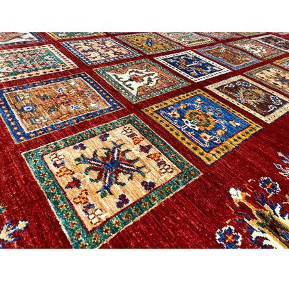 Detail of the red carpet with blue-and-yellow ornamental squares in a geometric grid