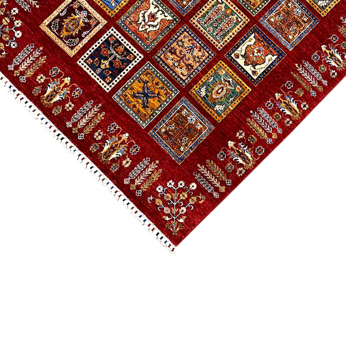 Red carpet with colorful ornamental squares and white fringe trim along the edge