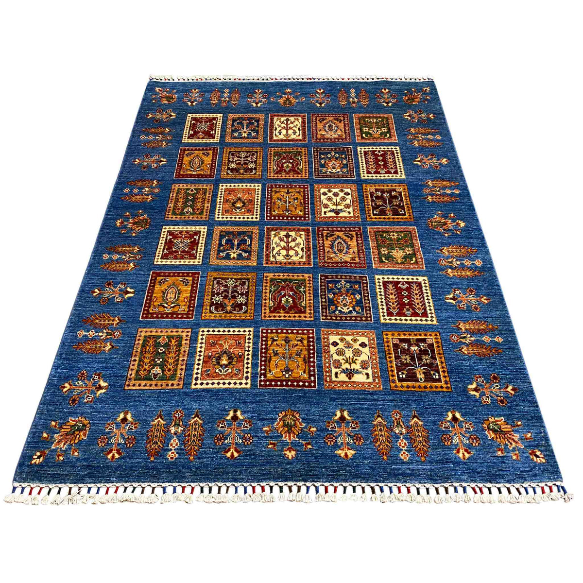Azur-blue rug with a rectangular pattern of many squares and colorful decorative elements