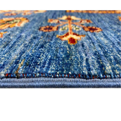 Carpet detail: azure pile texture with a colorful ornament and bordered edge area