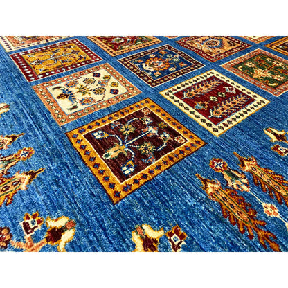 Close-up view of a rug with an azure-blue background, many colorful squares and ornaments
