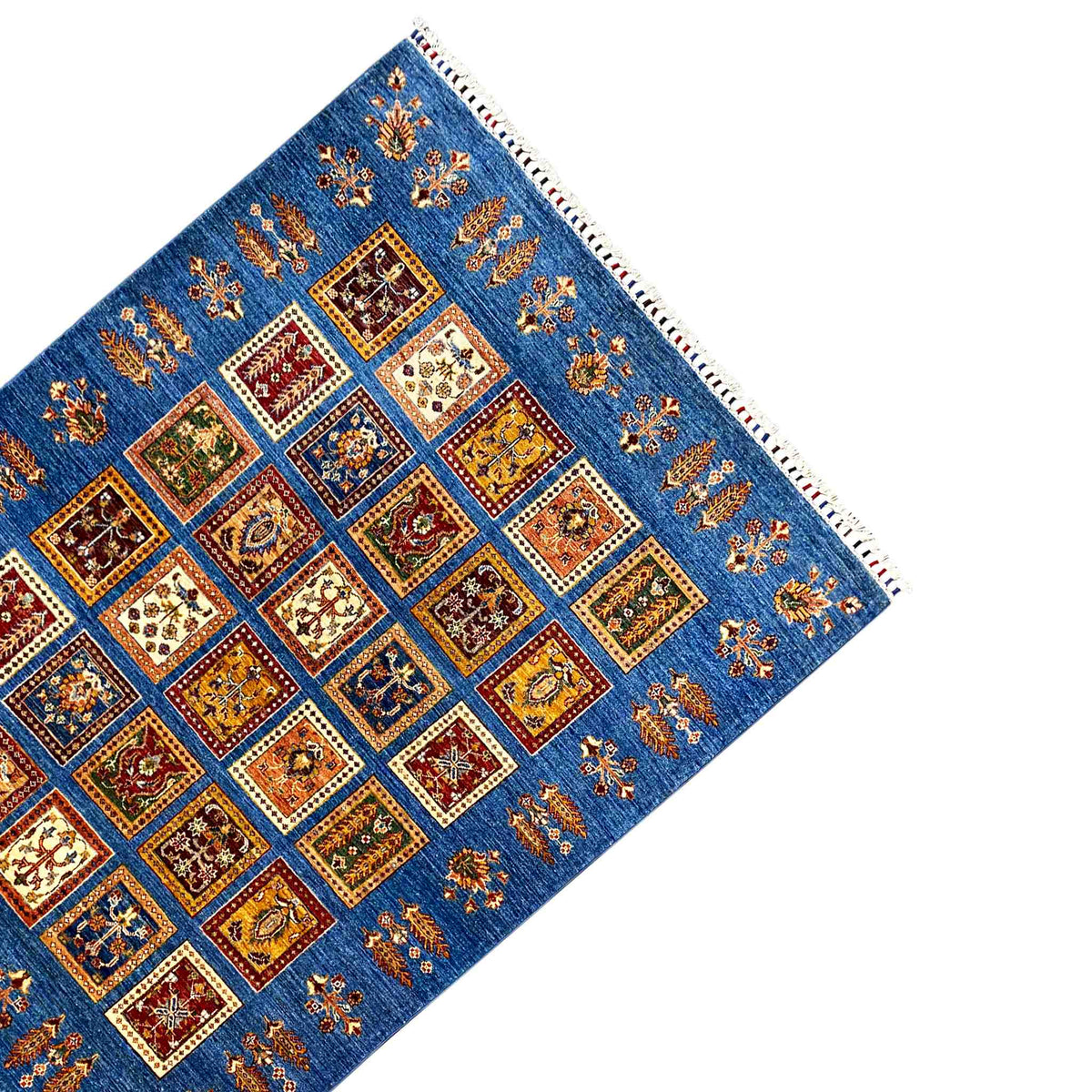 Rug with an azure-blue background, a centered square pattern, side border, and fringed edge
