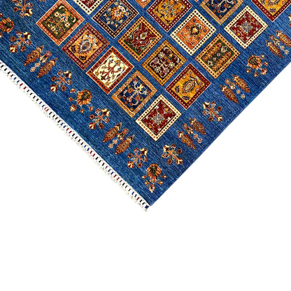 Carpet corner view with an azure-blue background, colorful squares, white fringe trim, and border