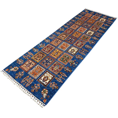 Angled runner rug: blue panel design with colorful ornaments and fringed trim
