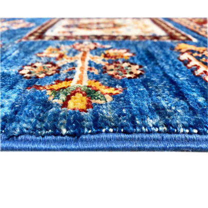 Close-up: blue runner rug with multicolored ornaments, textured pile