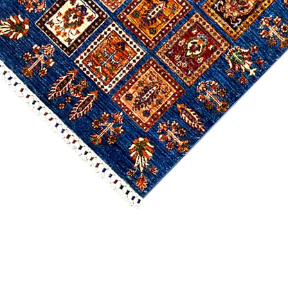 Edge detail: blue panel with colorful ornaments and white fringe