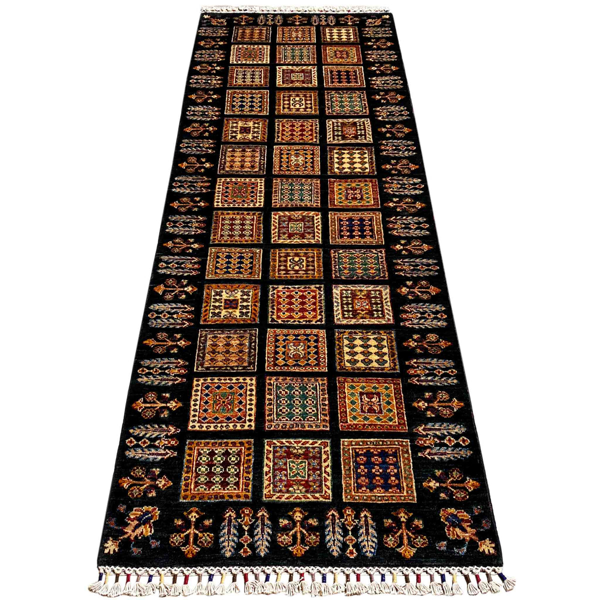 Runner rug with a wide central field of dark, colorful squares and fringes