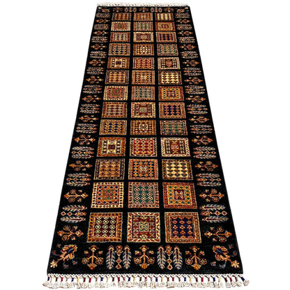 Runner rug with a wide central field of dark, colorful squares and fringes