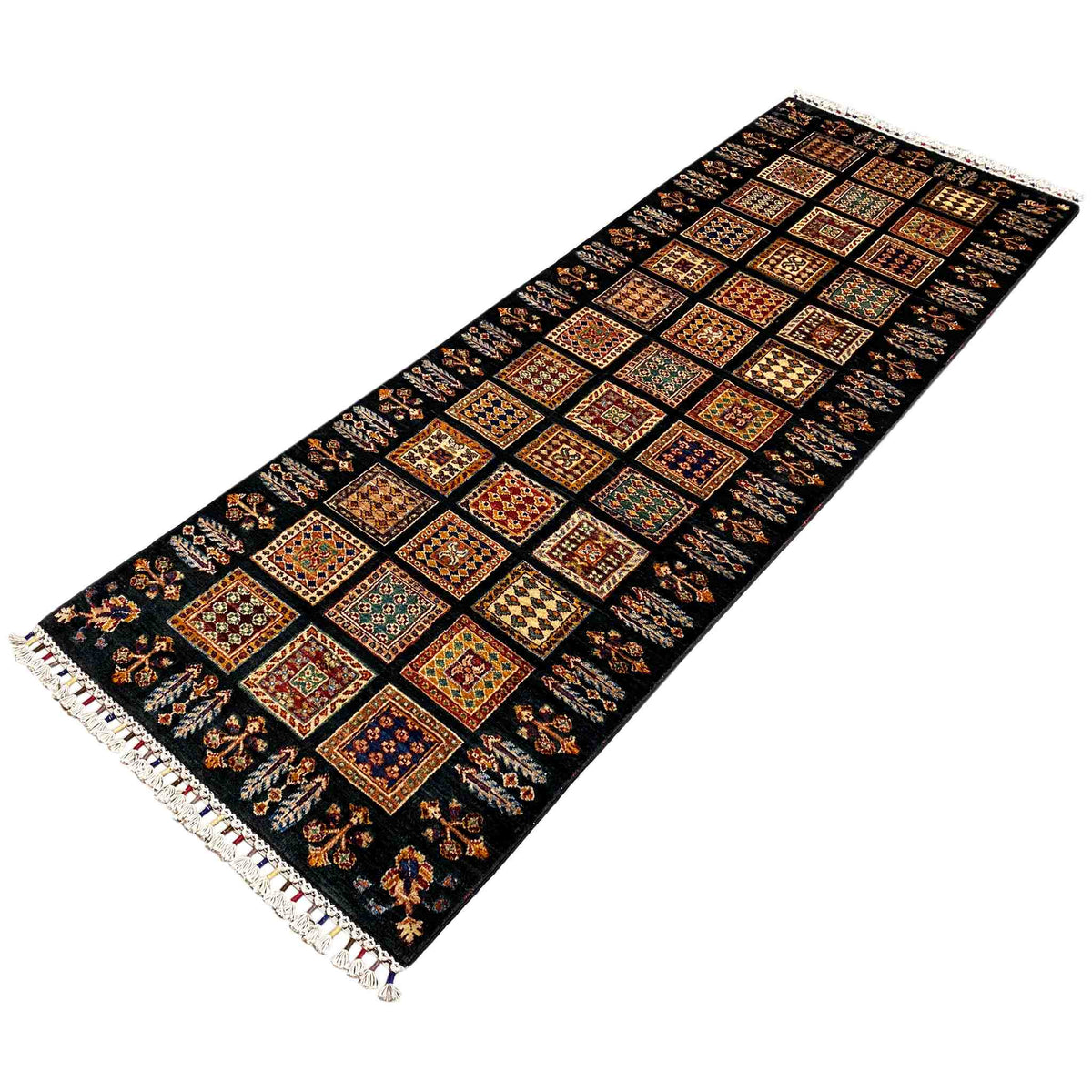 Runner rug from an angle above, dark background, colored squares, fringes on both sides